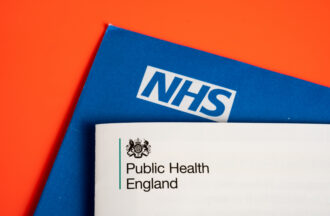 - OHE Public Health England logo seen on COVID vaccination brochure and NHS blue envelope Invitation for vaccination Stafford United Kingdom June 2 2021