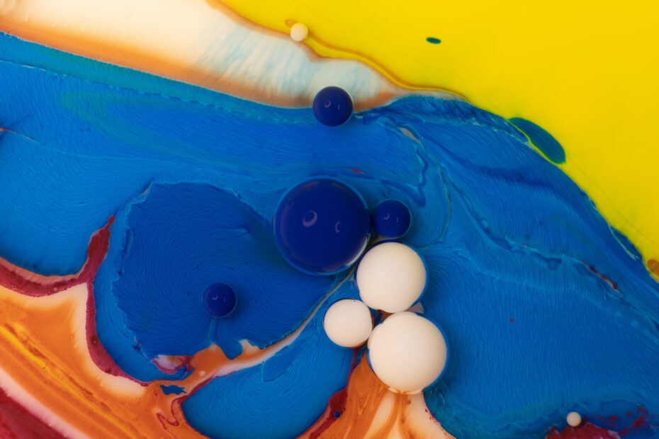 Overflows and bubbles of acrylic paint in liquid many colors