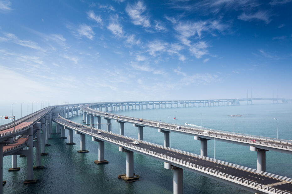 multiple bridges over the sea, in the back end of the picture all the bridges are turning right