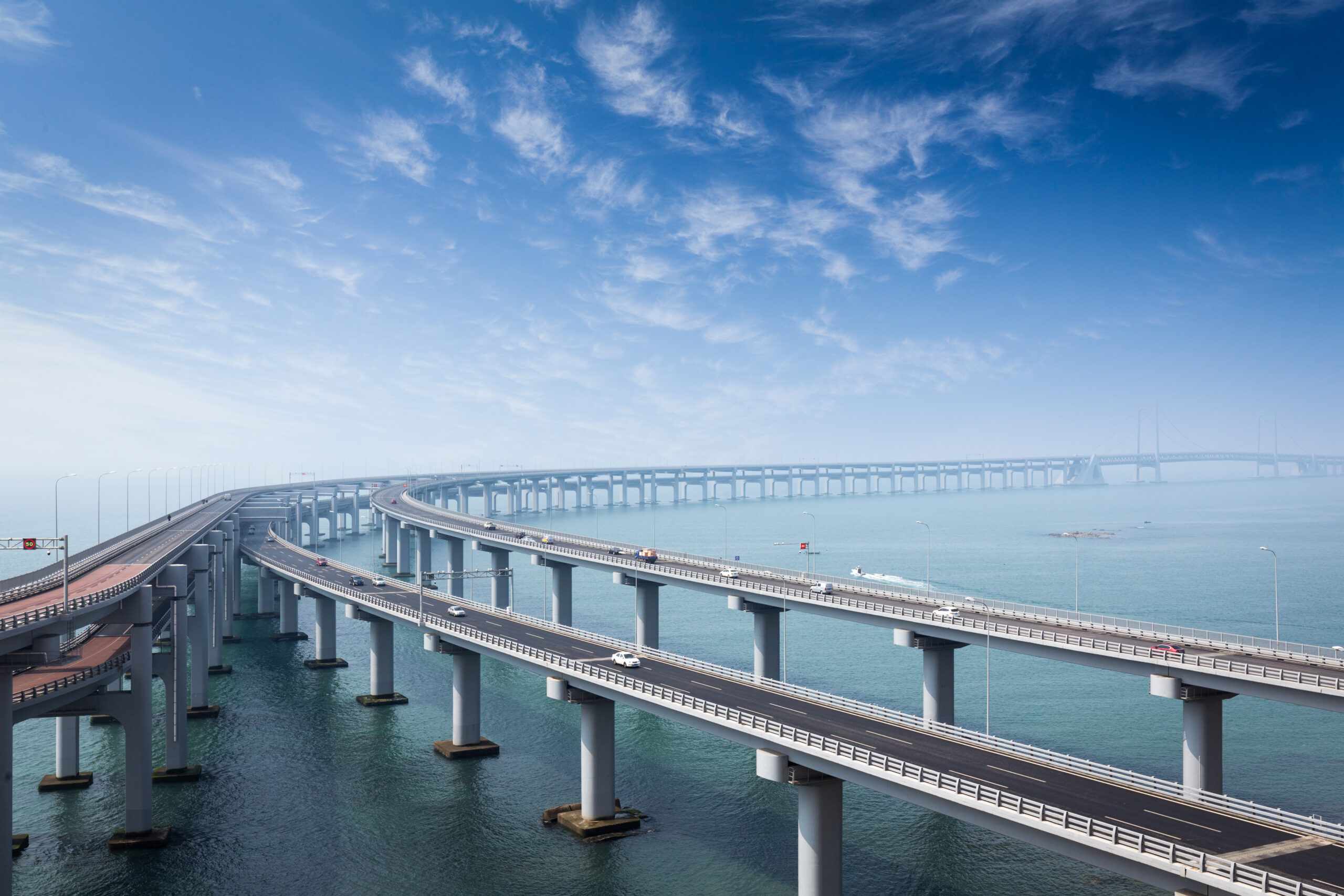 multiple bridges over the sea, in the back end of the picture all the bridges are turning right