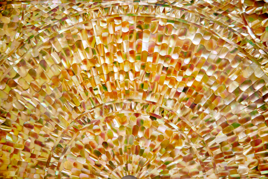 Antique Board Background made of colored mother-of-pearl pieces in the form of sun rays Design construction textures