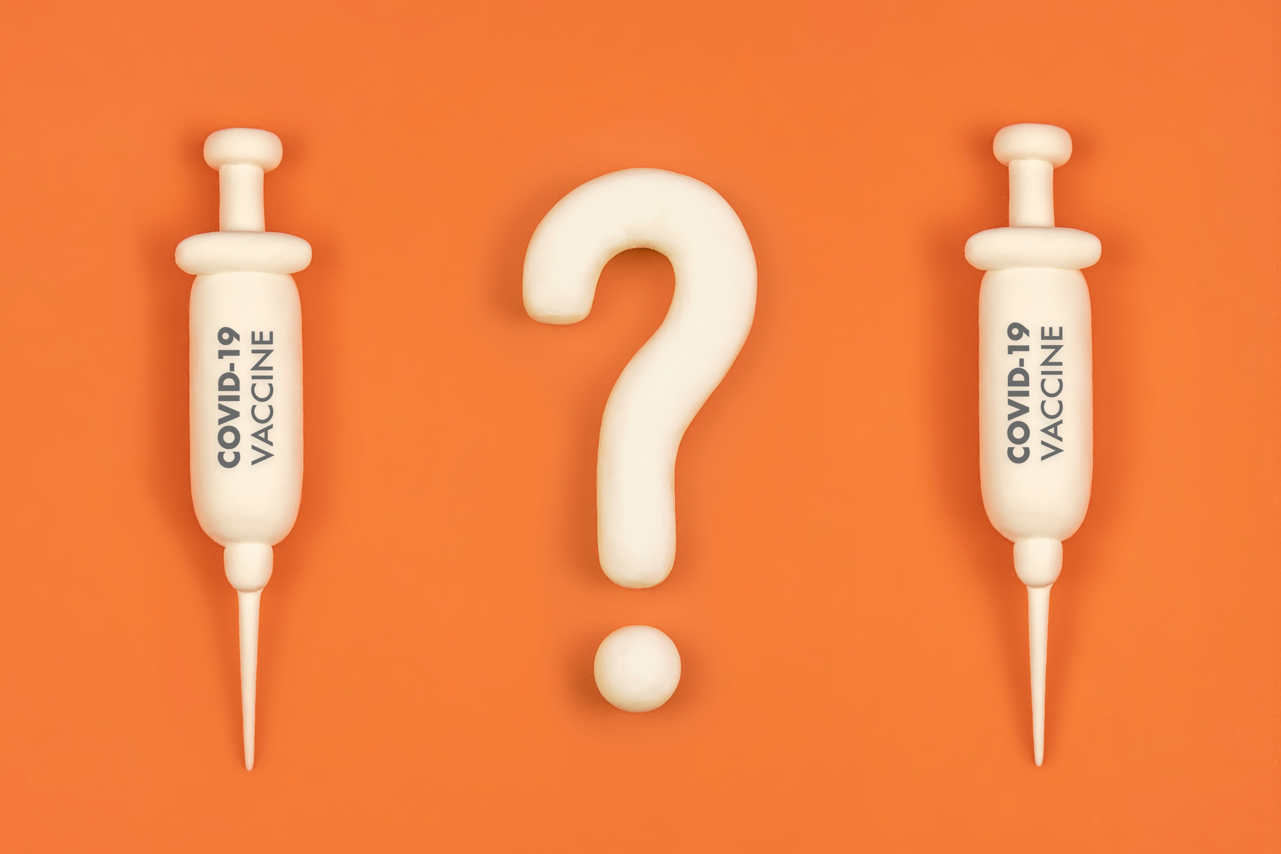 Vaccine hesitancy concept, syringes with vaccine and question ma - OHE
