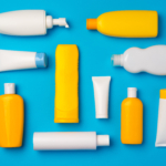 Bottles of sunscreen cream on blue background