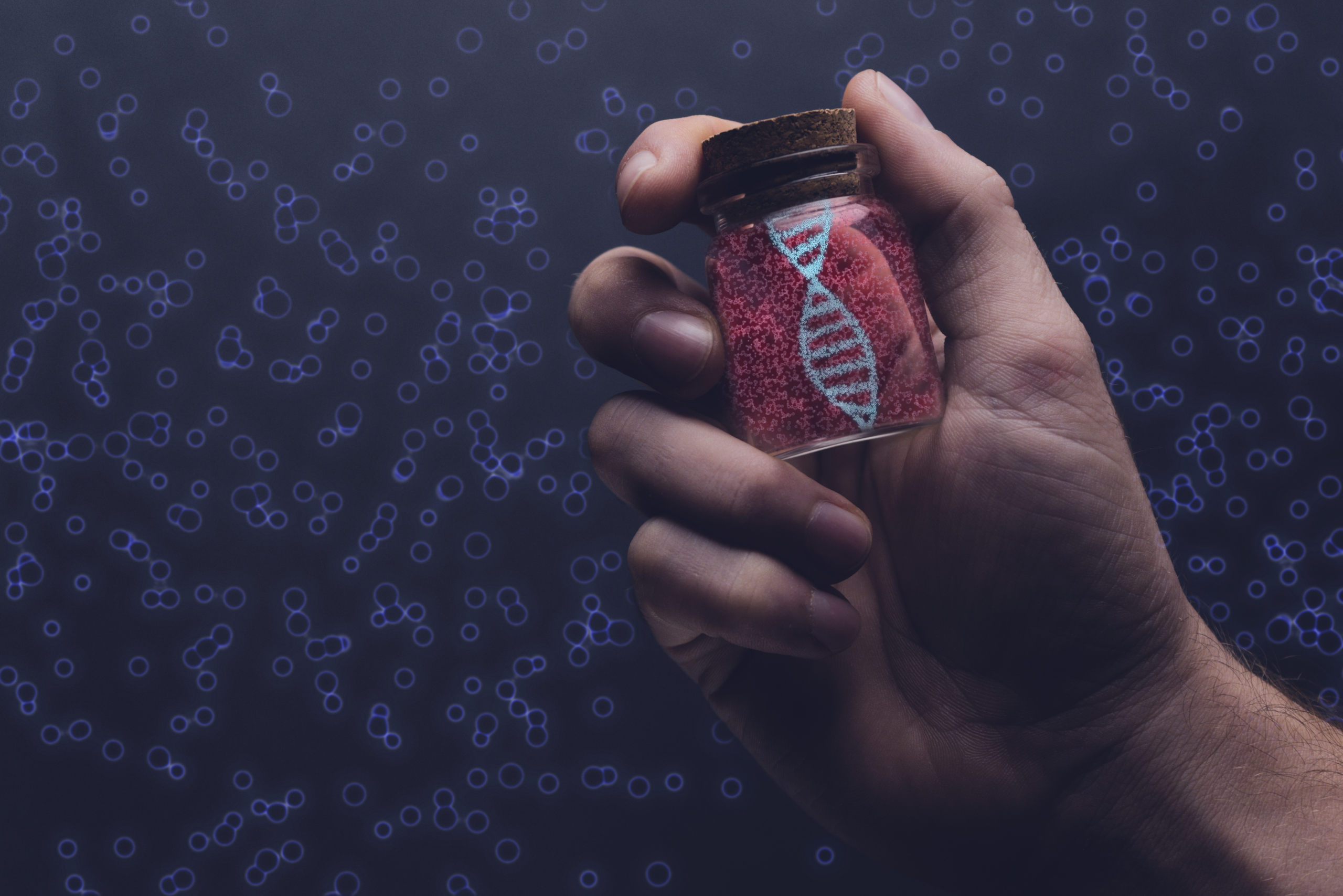 Close up of man holding DNA molecule in Glass bottle. Mixed medi