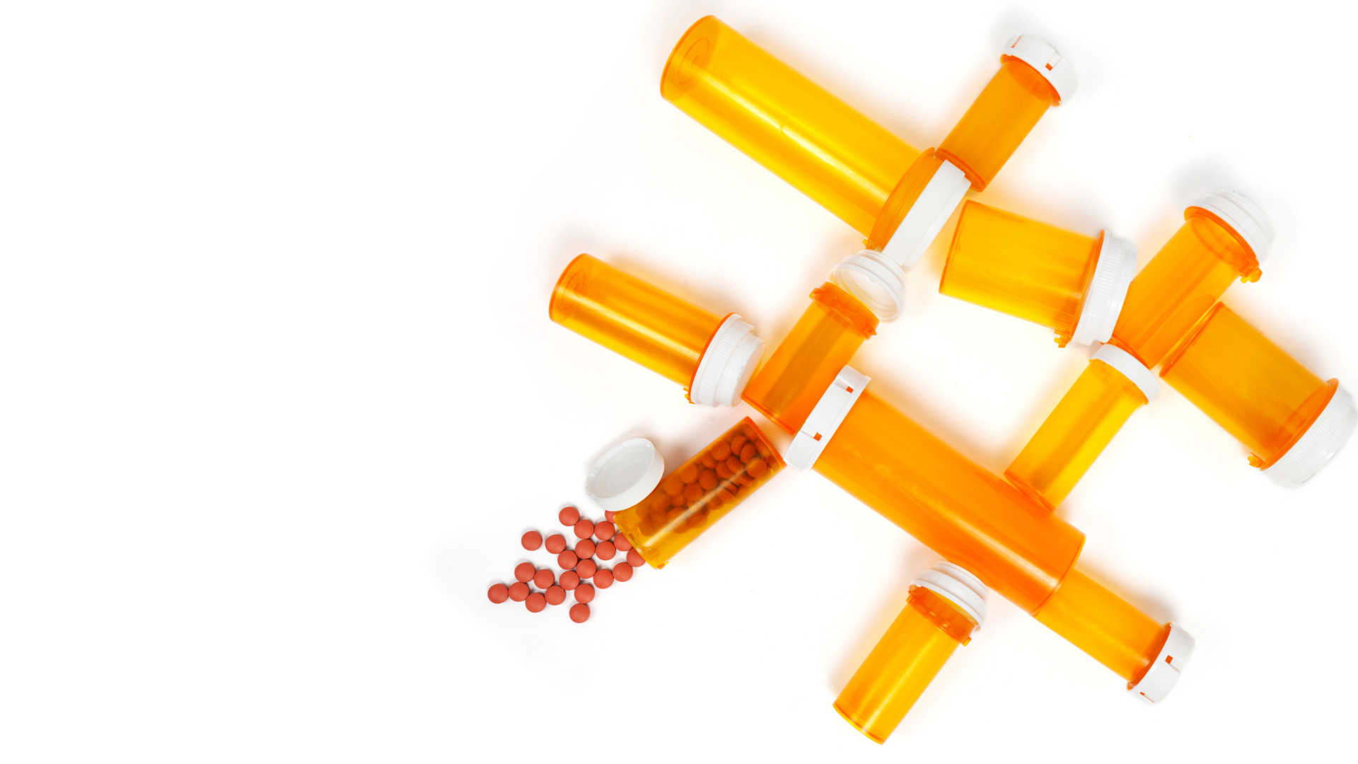 In a white background orange empty medicine holders forming an octothorpe. I holder is full and some red pills are flooding out of it.