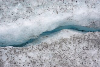 Cracks through the ice on a melting glacier in Alaska