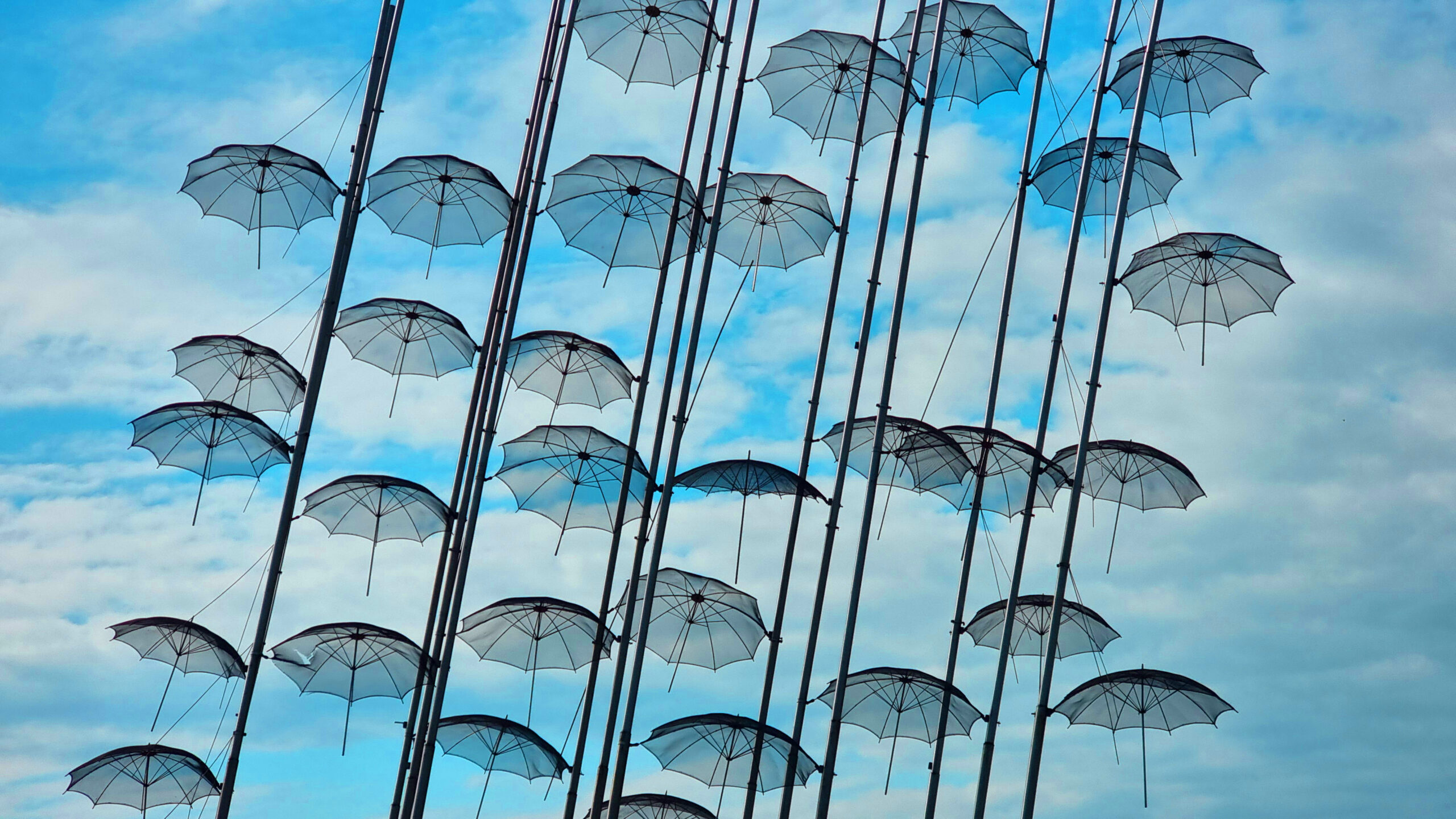 salonica umbrellas metallic street art sea fountain rain cloudy sky greece